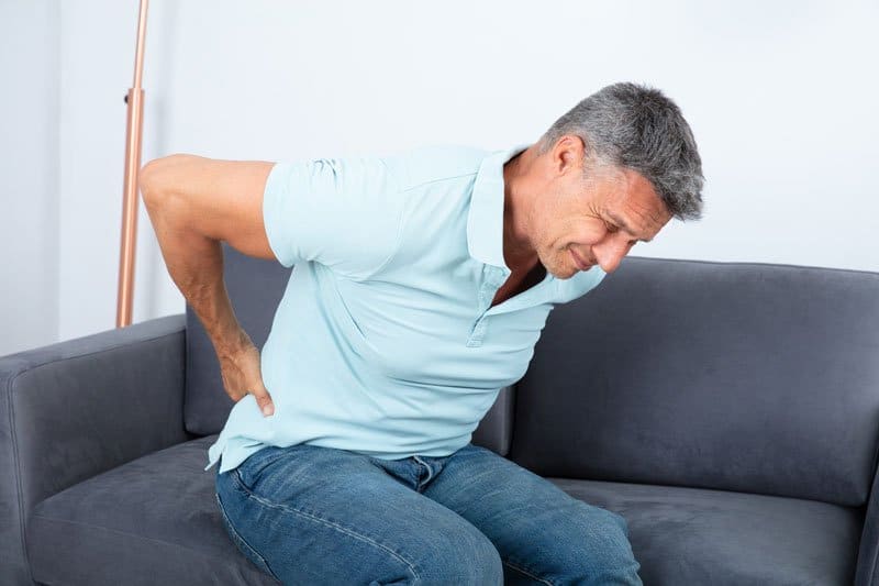 Senior man having a back pain from sudden movement