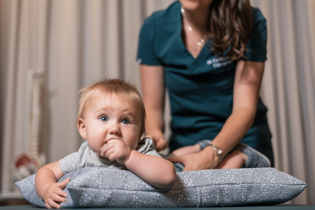 Female chiropractor giving pediatric chiropractic care to a baby
