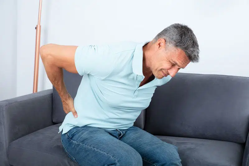 Man in pain needing chiropractic back pain treatment in the Woodlands.