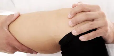 Chiropractor treating a patient with knee pain
