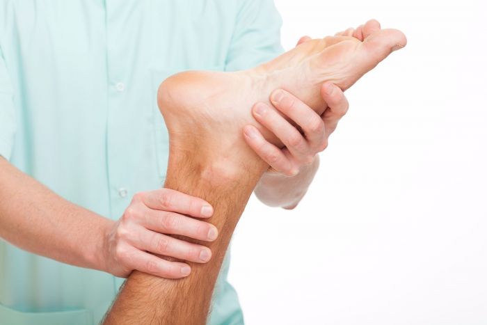 Chiropractor treating patient with plantar fasciitis condition.
