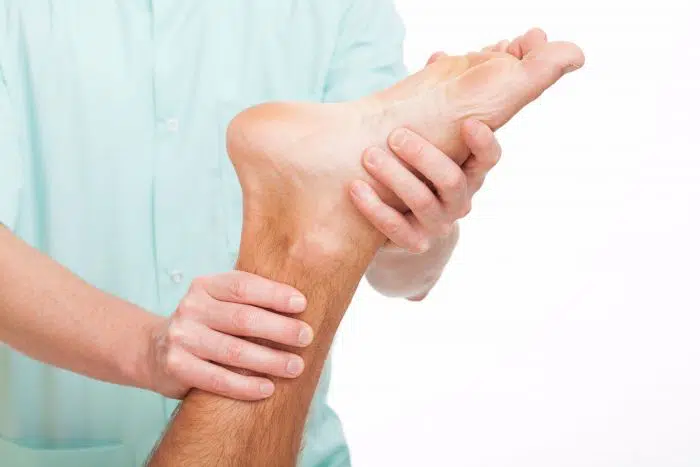 Chiropractor treating patient with plantar fasciitis condition.