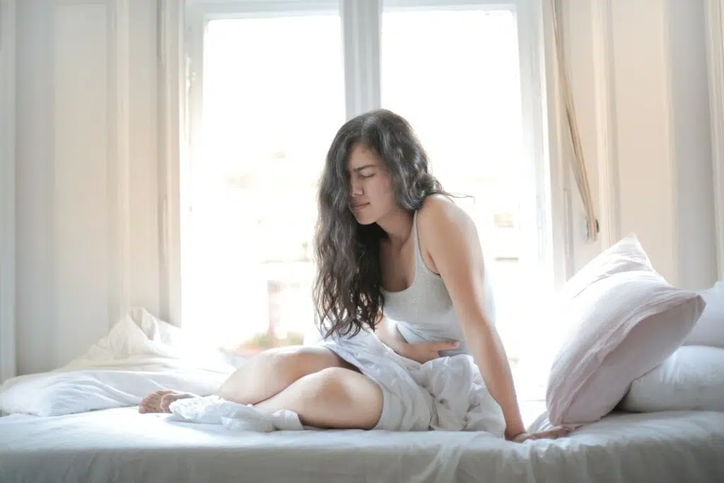 Girl in a bed having from pelvic pain