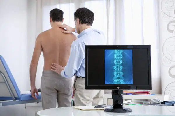 Chiropractor examining the patients spinal misalignments