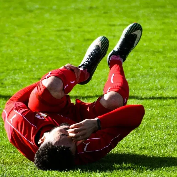 soccer player laying on the ground after a sports accident