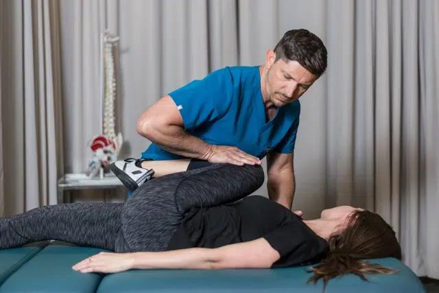 Chiropractor helps to treat a patient that suffers from joint stiffness at Core Health Spine & Rehabilitation 