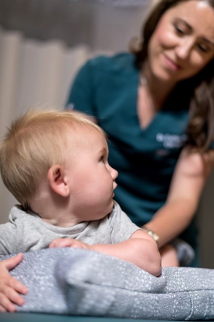 Female chiropractor in the Woodlands giving pediatric chiropractic care to a baby