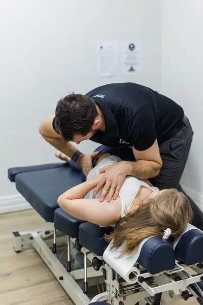 Chiropractor is doing some chiropractic adjustment to the patient