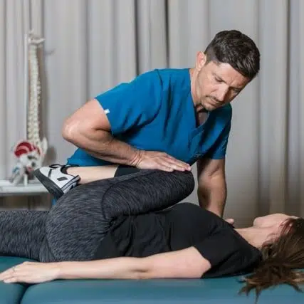 Chiropractor helps to treat a patient that suffers from joint stiffness at Core Health Spine & Rehabilitation