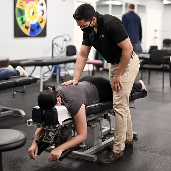 Chiropractor is doing some chiropractic adjustment to the patient