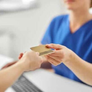 Patient is handling his healthcare insurance to the billing station