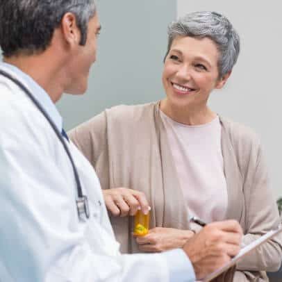 Chiropractor is having a conversation with her senior patient regarding the insurance