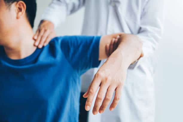 doctor assisting patient with muscle pain problems