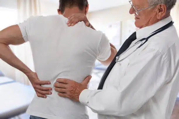 doctor examining the patients spine due to car accident 