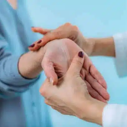 Doctor examining hand of senior patient with pain in wrist. Carpal tunnel syndrome.