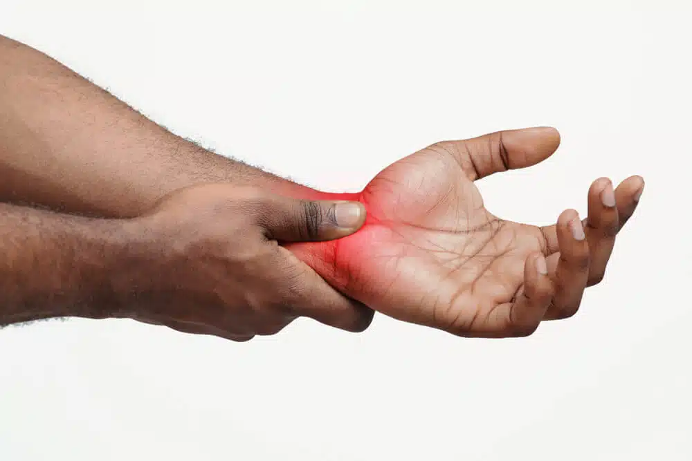 A man holding his wrist feeling pain caused by carpal tunnel syndrome 