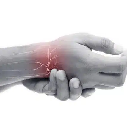 Man massaging painful wrist on a white background. 