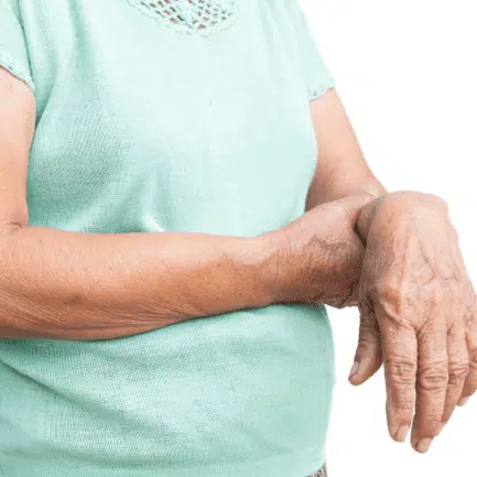 Senior woman holding her hand cause of muscle weakness.