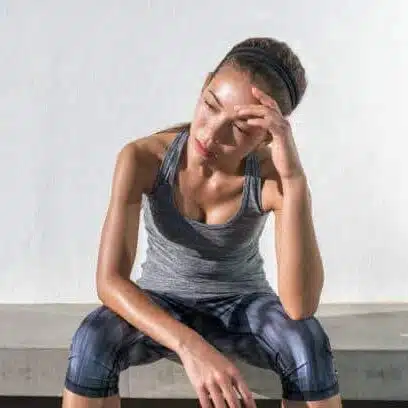 Young girl feeling of muscle spasm while doing some exercise under the sun 