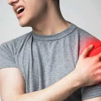 Image of a young man suffers from intense pain caused by swelling of his shoulder.