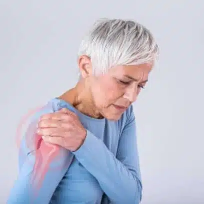 Senior woman holding her shoulder feeling of too much pain caused by Arthritis.