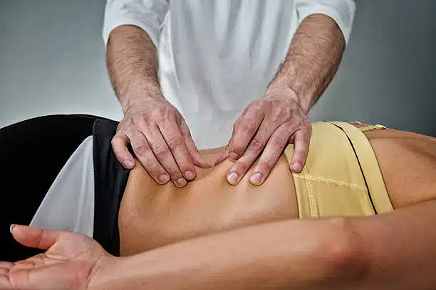 Physical therapist helping a client with pain management in The Woodlands