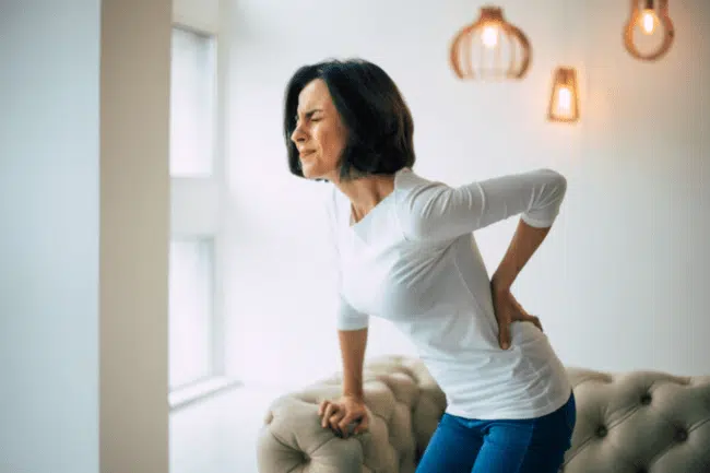 Woman suffers from chronic pain feeling of too much pain from back.