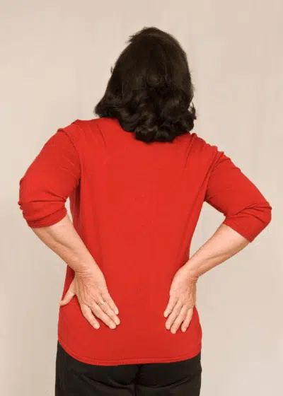 Middle aged woman suffers from lower back pian and arthritis.