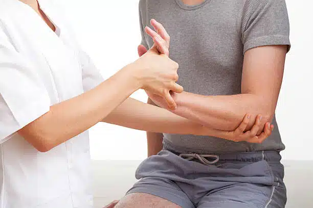 Physiotherapist doing some physical therapy treatment to a patient suffers from Carpal Tunnel Syndrome.