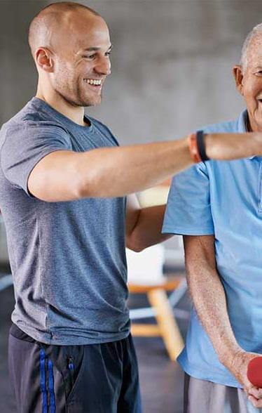 Physiotherapist helping a senior man to under go a physical therapy.