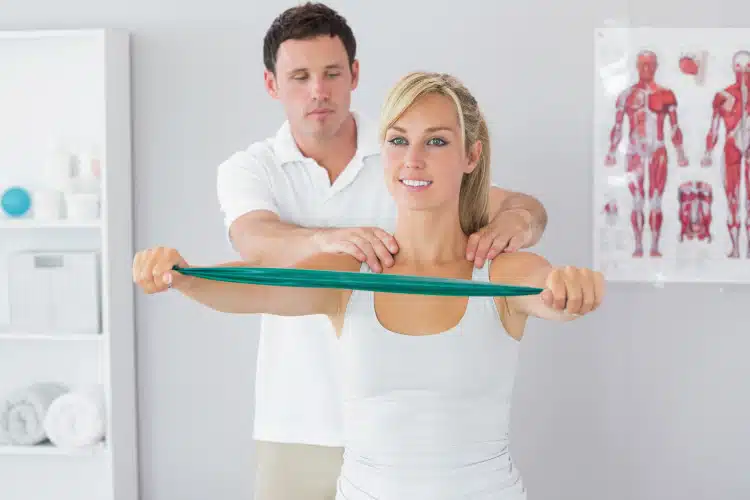 Chiropractor is helping his patient to correct her body posture and position.