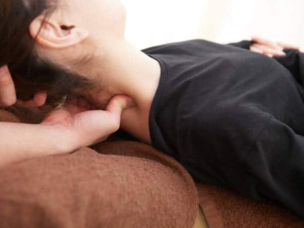 Chiropractor doing some  neck and spine adjustment to the patient.