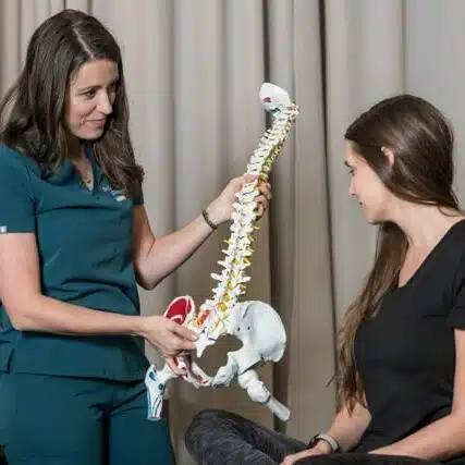 Chiropractor having an evaluation with a patient at core health chiropractic clinic.