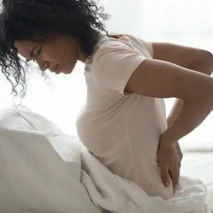 Woman having a difficulty in sleeping cause of back pain