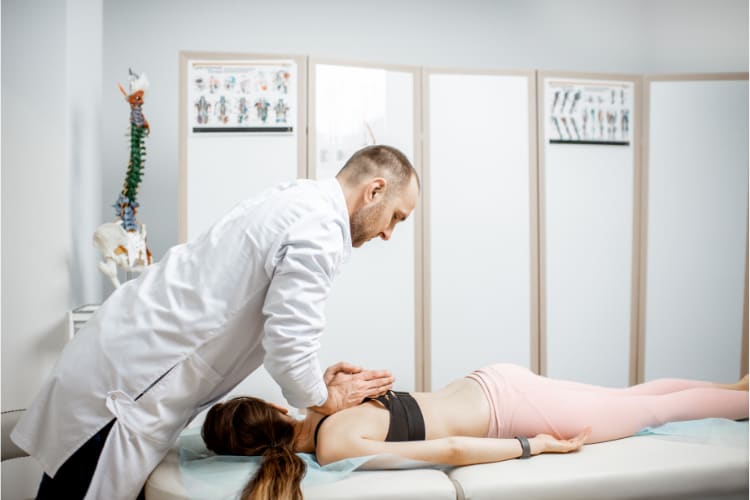 chiropractor doing spinal adjustment to a patient