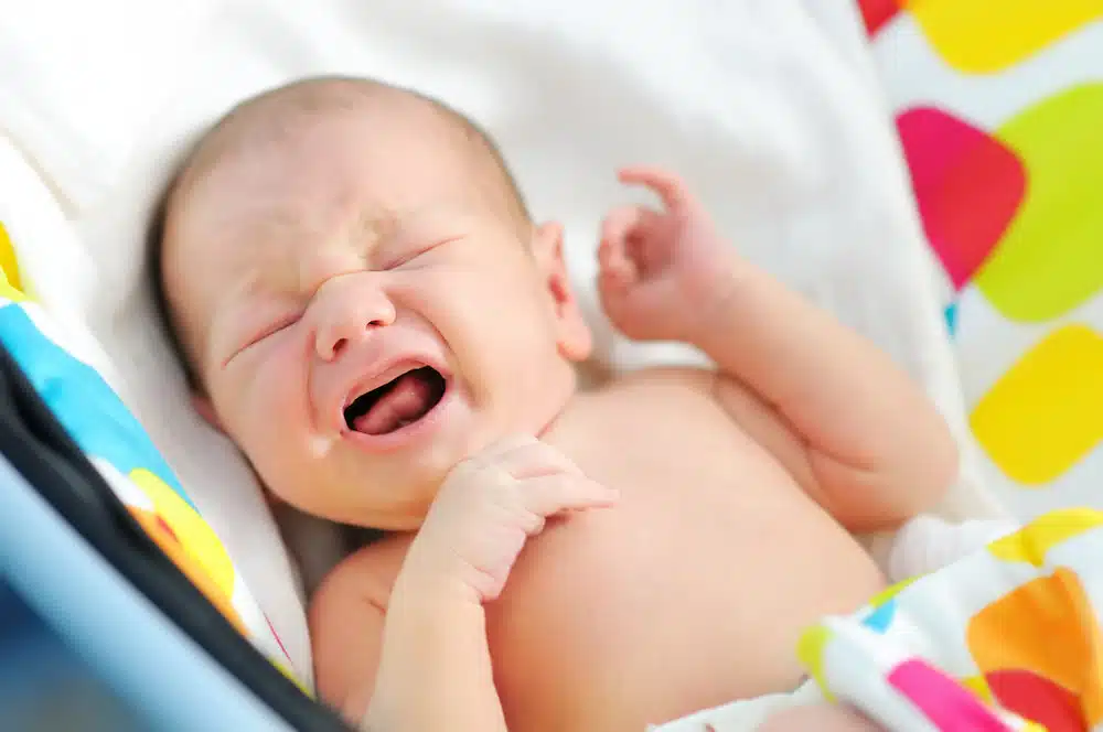 persistent crying and discomfort associated with colic experienced by a newborn which can be treated by newborn chiropractic care