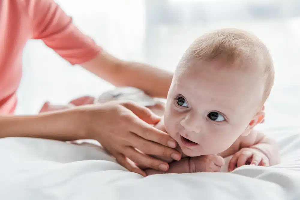 newborn infant getting chiropractic care with massages