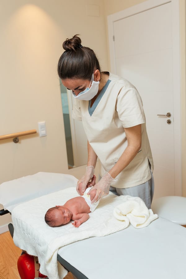 Experienced and Certified chiropractor doing therapy on a newborn infant