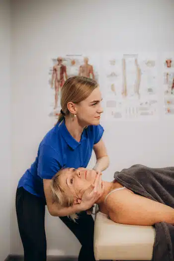 chiropractor treating patient with pinched nerve on neck