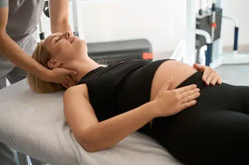 expert in prenatal chiropractic care doing massage on pregnant mother