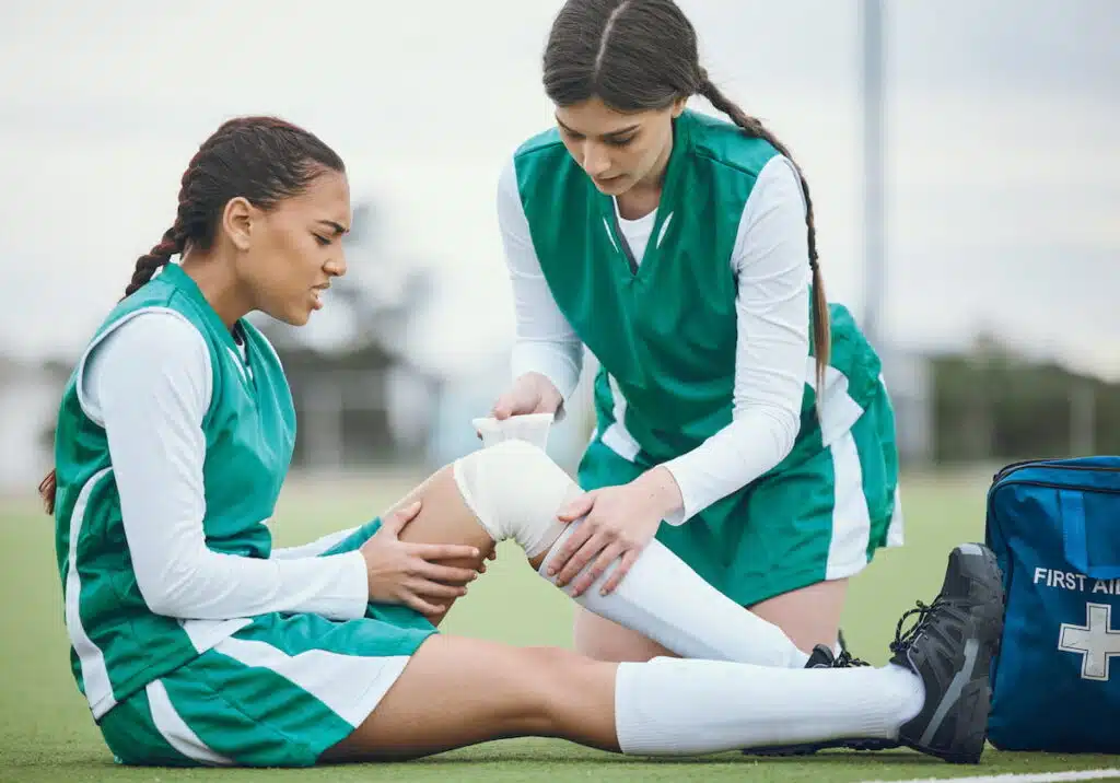 teenager playing soccer gets injured during a game