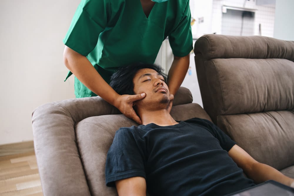 Physiotherapist giving neck massage