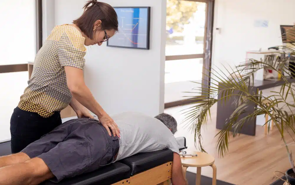 Chiropractor doing some back adjustment to the patient