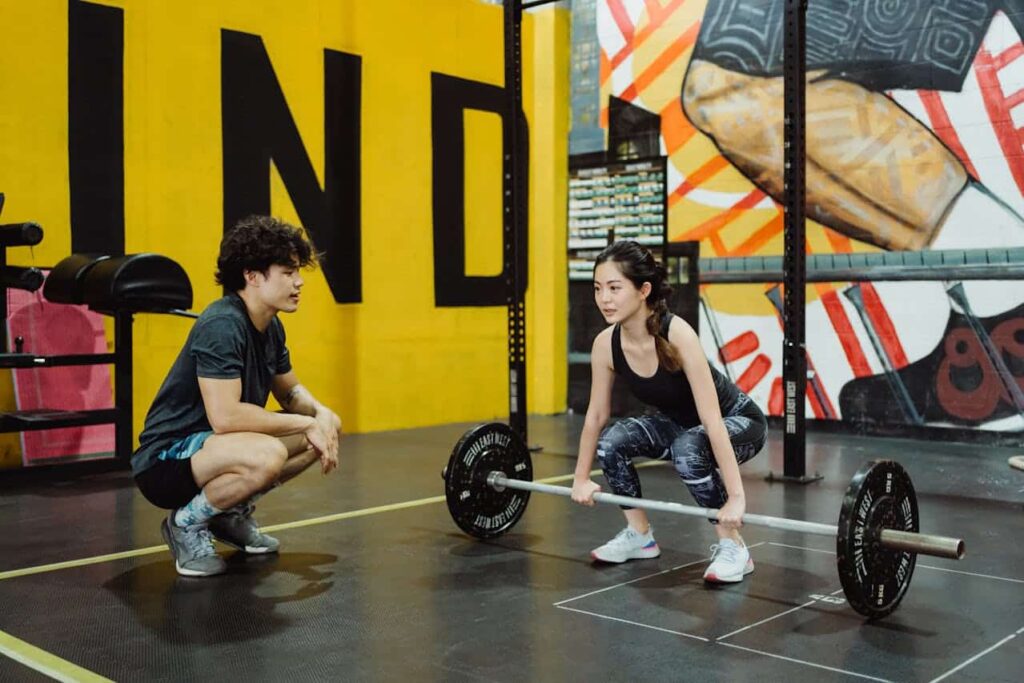 Athlete performing guided strength training during sports injury rehabilitation.